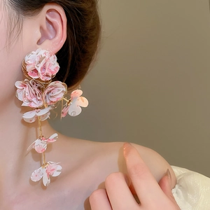Close-up of long chiffon fabric flower tassel earrings with pink gradient petals