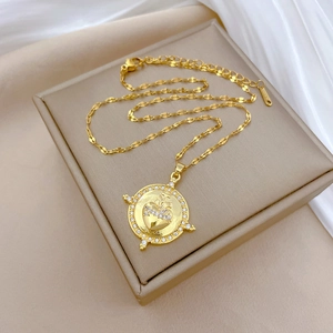 Macro view of gold sacred heart pendant necklace with shimmering zircon stones and flat chain