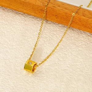 Macro view of gold-plated hexagonal pendant necklace with sparkling zircon stone