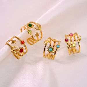 Gold celestial rings with sun moon stars and colorful natural gemstones on silk