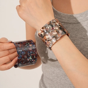 Detail of vintage acetate wide open cuff bangle with tortoiseshell and floral patterns