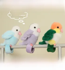 Plush parrot keychains with flexible snap bands clinging to a metal bar