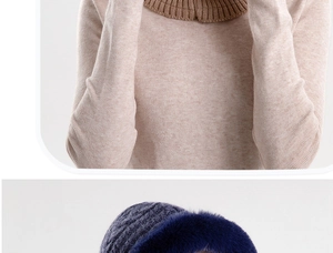 Detail of light brown ribbed knit scarf and navy knit hat with plush blue faux fur trim