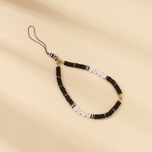 Detail of beaded phone wrist strap with black clay discs and golden LOVE letter beads