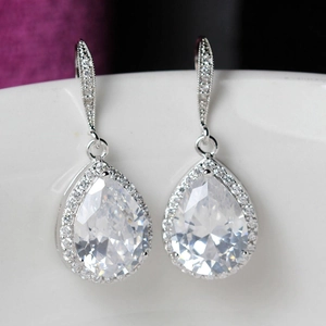 Macro shot of silver drop earrings featuring pear-cut cubic zirconia and pavé stones