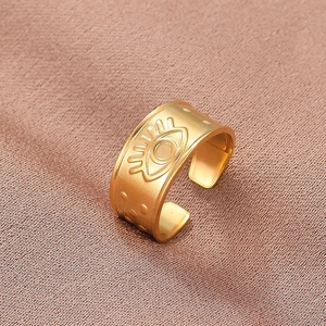 Matte gold adjustable evil eye ring with bohemian style on champagne silk fabric