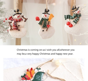 Detailed close-up of resin snowman pendants and sleigh decor with vintage hemp rope