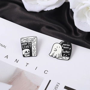 Skull book and ghost enamel pins with never been better text on black satin