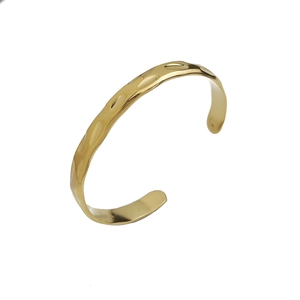 Gold open cuff bracelet with minimalist hammered texture in stainless steel