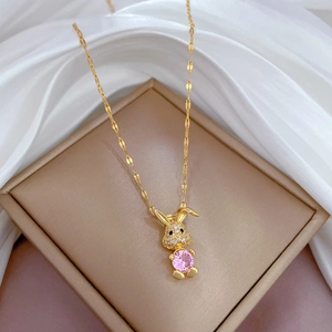 Titanium steel necklace with pink rabbit pendant on champagne jewelry box display