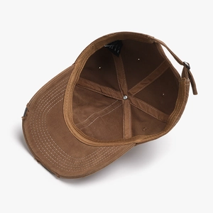 Vintage brown distressed cotton baseball cap with adjustable metal strap and ripped detail
