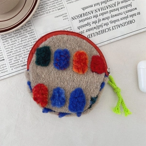 Detail of round colorful wool felt storage bag with red zipper and vibrant puller