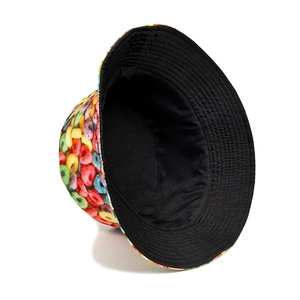 Reversible bucket hat featuring colorful donut print and solid black minimalist design