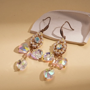 Detail of vintage palace style earrings with hollow drop-shaped crystals and pearls