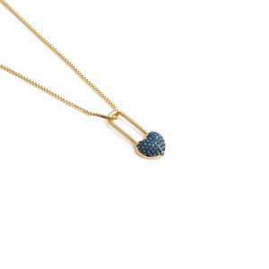 Detail of gold box chain necklace with heart lock pendant inlaid with blue zircon
