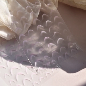 Detailed view of gradient pink crescent moon French manicure nail art stickers on silk