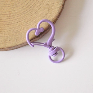 Macro view of purple heart-shaped lobster clasp with smooth painted metal finish