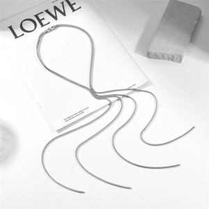 Detailed shot of silver stainless steel fringe chain necklace set on minimalist background