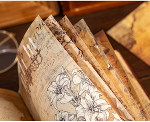 Close-up of European retro journals with gold foil patterns and floral illustrations
