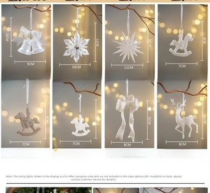 Detailed view of white glitter Christmas ornaments in star, bell, and snowflake shapes