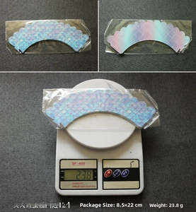 Macro detail of holographic mermaid cupcake wrappers showing double-sided scales and grid