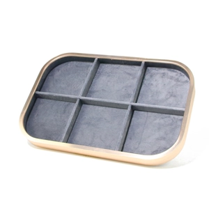 Detailed macro view of 6-slot jewelry tray with rose gold metal frame and grey velvet lining
