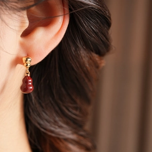 Detail of 18k gold plated red gourd earrings on model for an elegant Chinese style