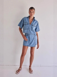 Chic two-piece blue denim set with short sleeve collared top and asymmetric mini skirt