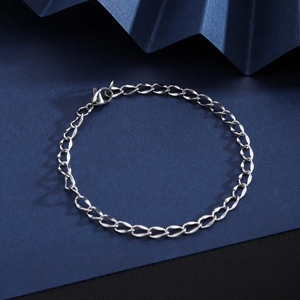 Detailed close-up of a silver stainless steel Cuban chain bracelet with a lobster clasp