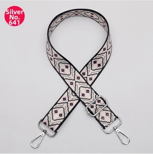 Close-up of adjustable ethnic jacquard shoulder strap with silver metal lobster clasps