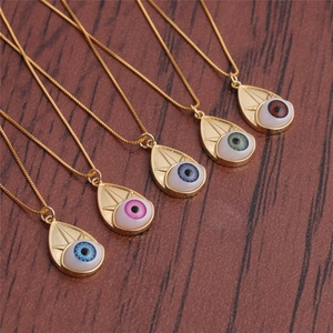 Five gold evil eye teardrop necklaces in blue, pink, and green on wooden background