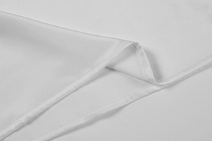 Detailed close-up showing the precise single-needle stitching on white silk fabric