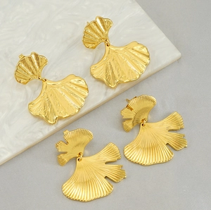 Detailed view of golden ginkgo leaf earrings with realistic vein texture and metallic finish