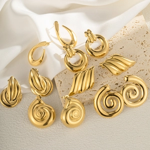 Elegant gold alloy conch shell earrings in various geometric styles on white silk fabric