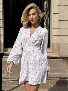 Elegant white floral V-neck mini dress with lantern sleeves and button waist detail