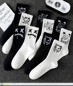 Detail of cotton crew socks with graffiti prints featuring Monster and Stay Wild text