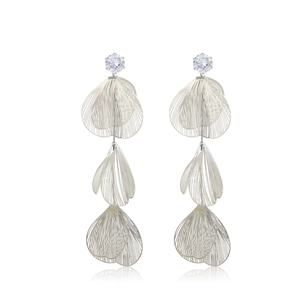 Macro detail of silver layered wire petals and zircon on long tassel earring