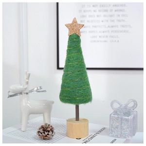 Close-up of a pink felt Christmas tree with a golden star and a natural wooden base