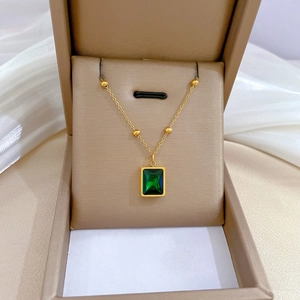 Titanium steel gold necklace with square emerald pendant in a jewelry box