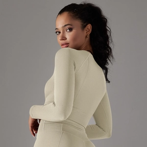 Detail of light beige seamless yoga top with honeycomb texture and tight fit