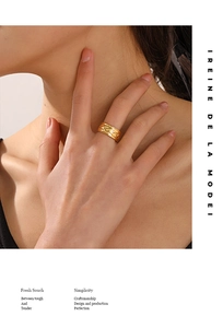 Fashionable 18K gold plated stainless steel wide ring shown on a finger with embossed detail
