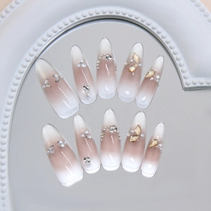 Cat eye pearl press-on nails with shimmering diamonds and cat eye gradient effect