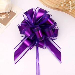 Detail of purple organza gift bow with satin trim for festive holiday packaging