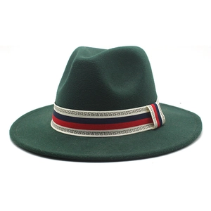 Detail of dark green wool fedora hat featuring red and blue Greek key patterned ribbon