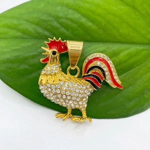Detail showing a gold-plated rooster pendant with clear crystals and red enamel accents