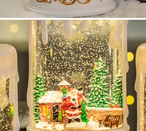 Close-up of a Christmas candle water globe with Santa Claus and festive glitter effect