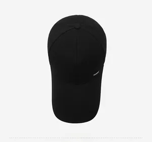 Top-down view showing six-panel canvas construction of black baseball cap with logo