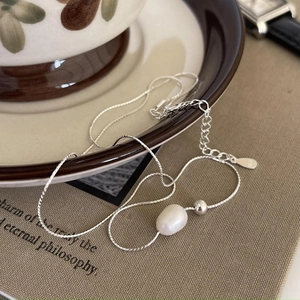 Elegant S925 silver necklace featuring a white pearl and polished bead on a fine chain