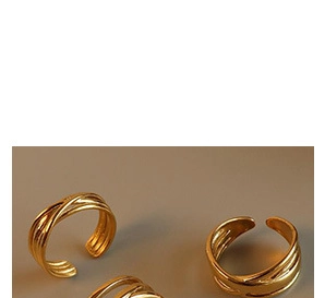 Close-up of gold-plated twisted U-shape stackable rings with a polished mirror finish
