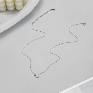 Close-up of S925 sterling silver necklace featuring a double heart pendant with sparkling pavé